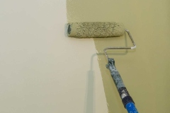 Apartment renovation the worker painting apartment wall on surface wall by roller brush